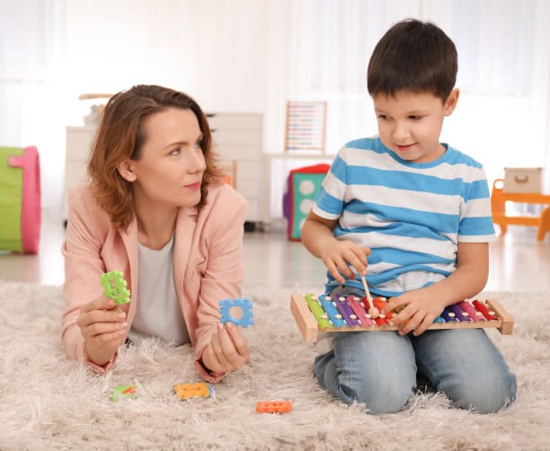 Boy High Fiving Therapist During Learning
