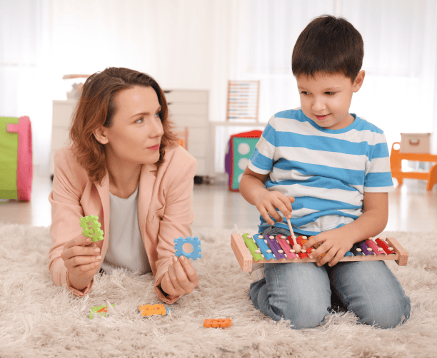 Boy High Fiving Therapist During Learning