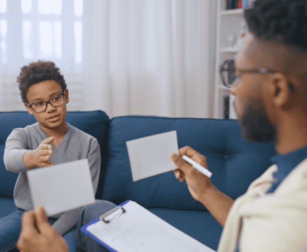Child In Therapy Identifying Images With Therapist
