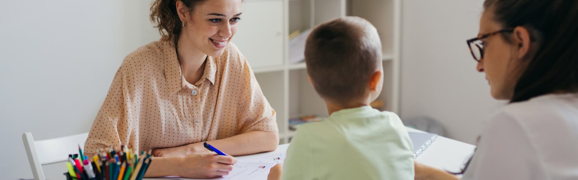 Child Assessment Meeting With Parents And Teacher