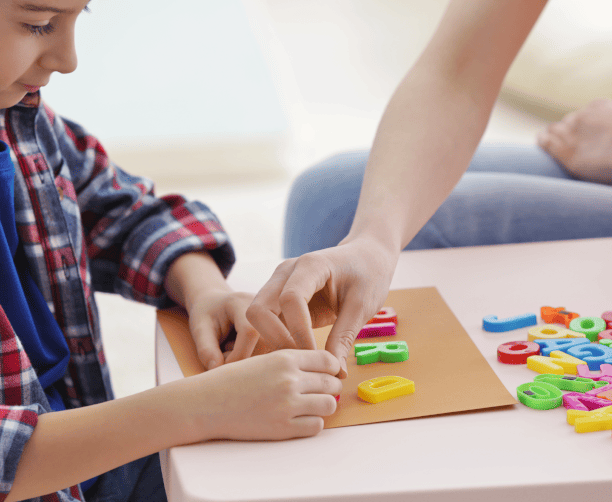 Child Learning Letters With Therapist