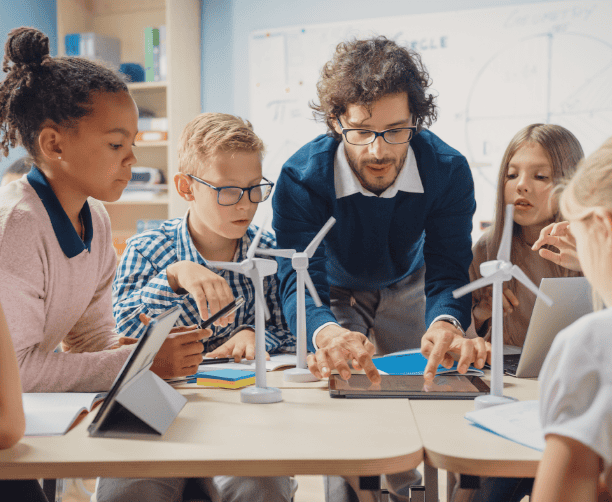 Girl Smiling And Writing In Classroom