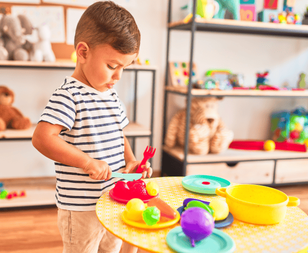 Kids Doing Halloween Craft With Teacher Help