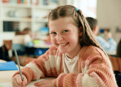Students Coloring With Teacher In Classroom