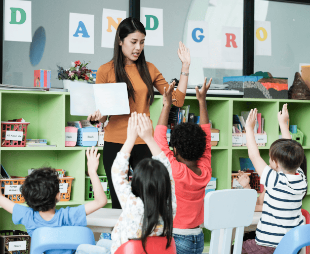 Students Engaged Raising Hands During Lesson