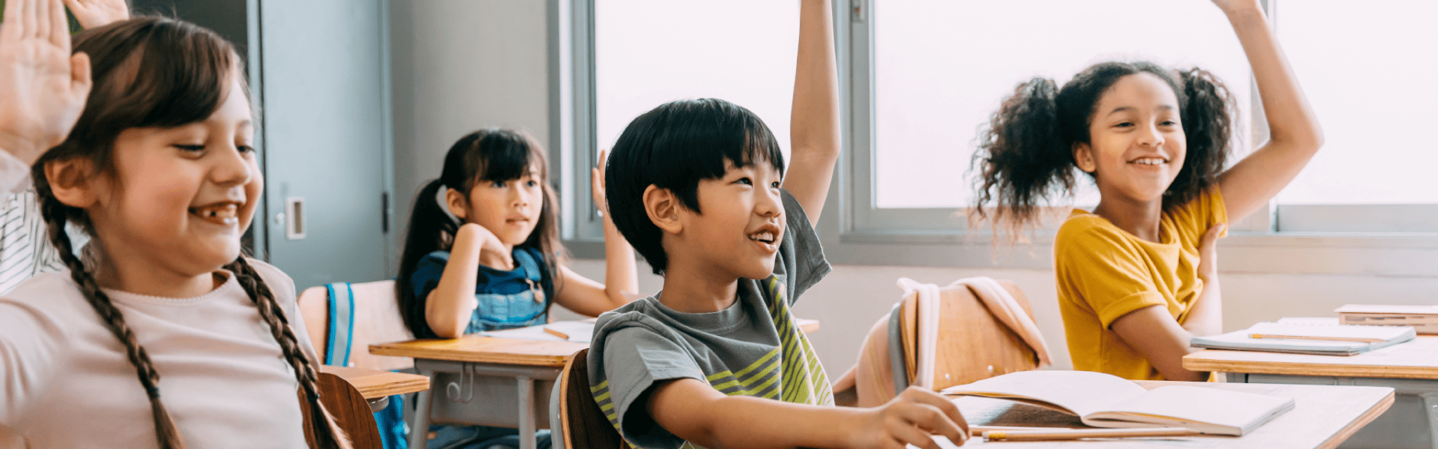 Teacher Calling On Students In Classroom
