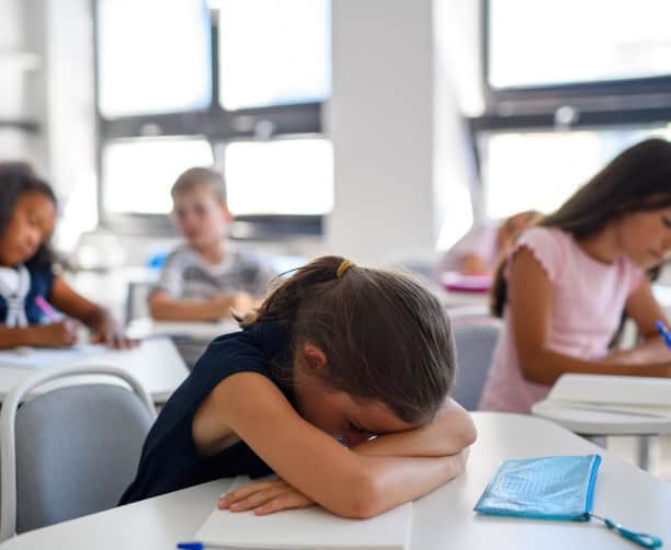 Teacher Guiding Students On Laptop Research