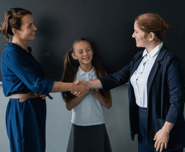 Teacher Parent Handshake With Student Present
