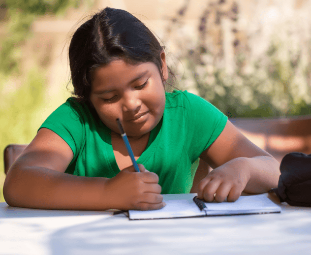 Teacher Reading To Children Under Tree