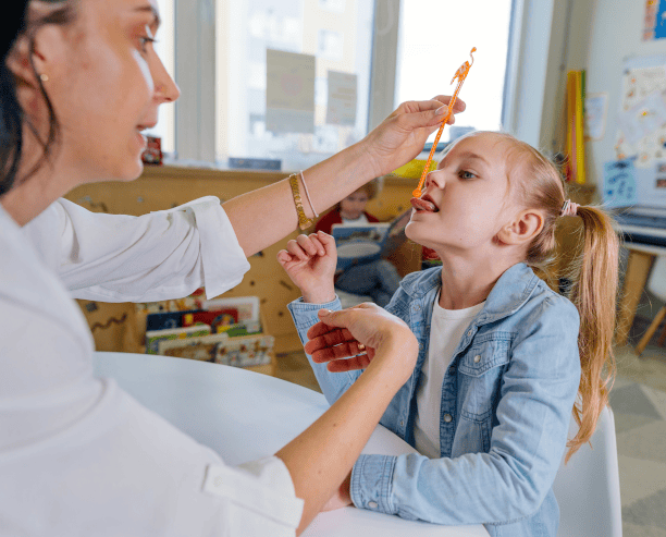 Therapist Using Tongue Tool With Child