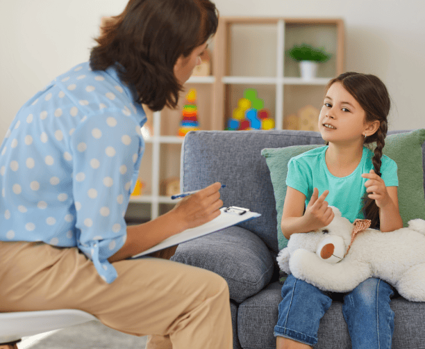 Young Girl Sharing In Therapy Session With Counselor